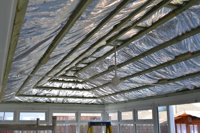 Conservatory Roof Insulation Being Installed On Roof.